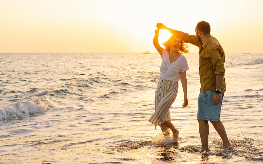 Young Romantic Couple Dancing Turning Around By Sea. Seascape At